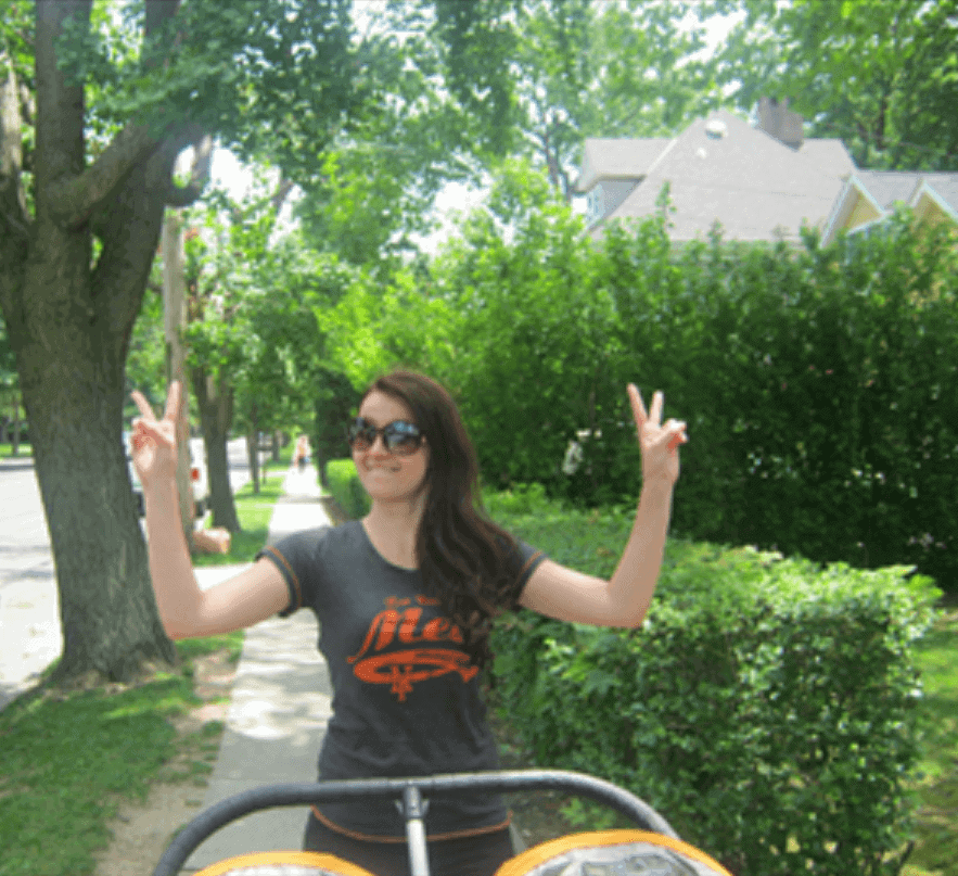 woman pushing stroller showing peace signs