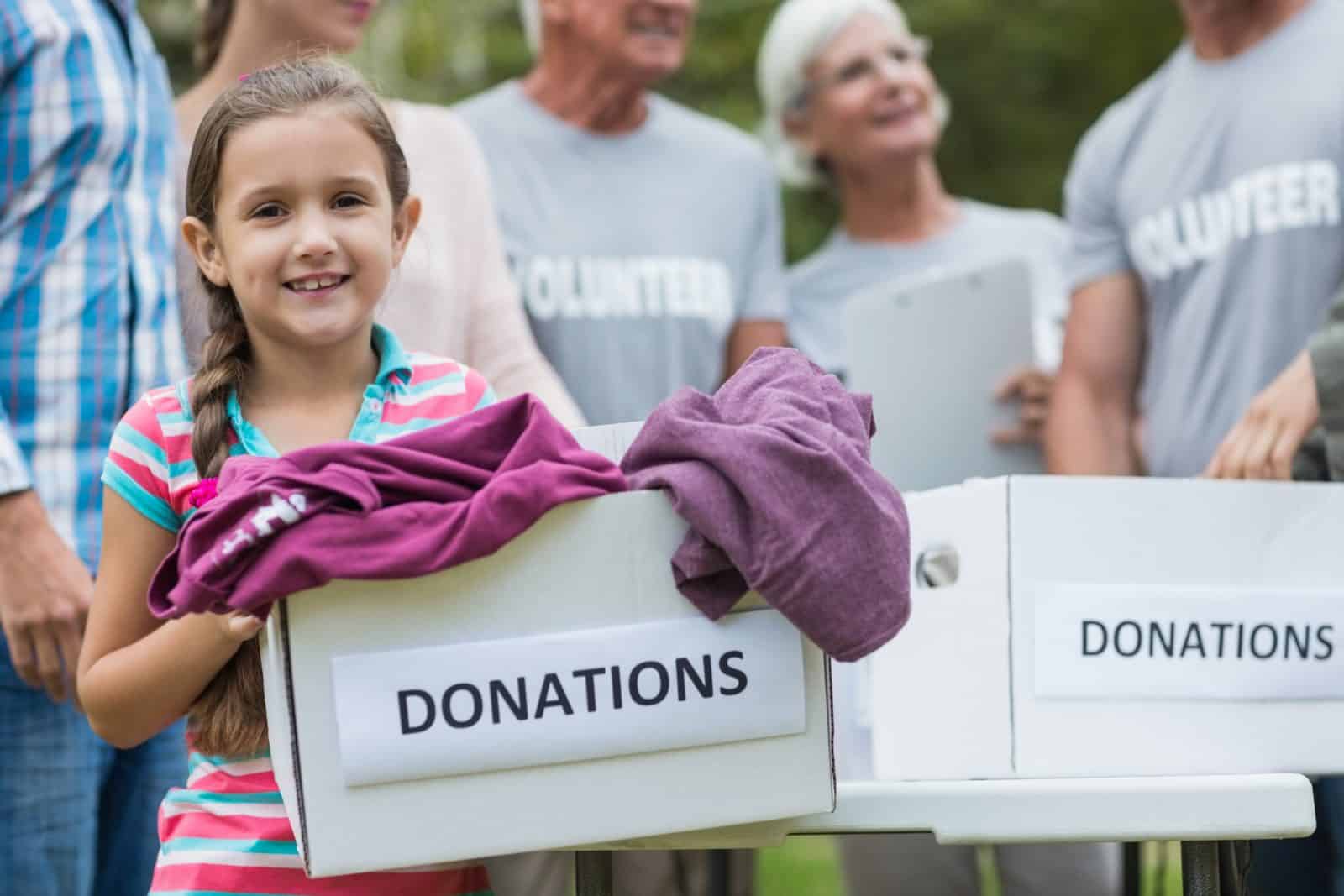 child with donations box