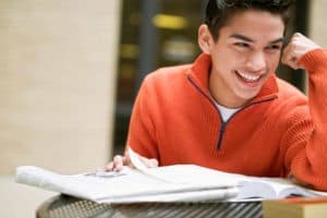 young man smiling with book