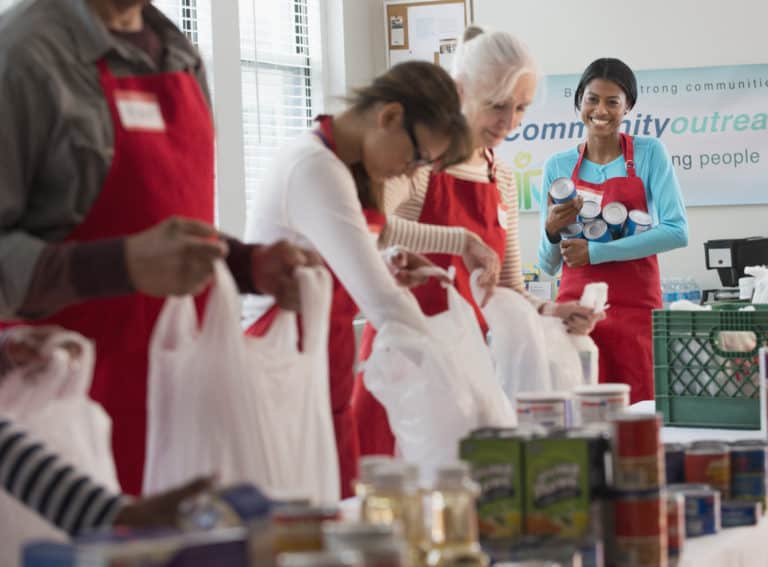 us-nanny-institute-volunteers-packing-canned-goods-at-food-drive