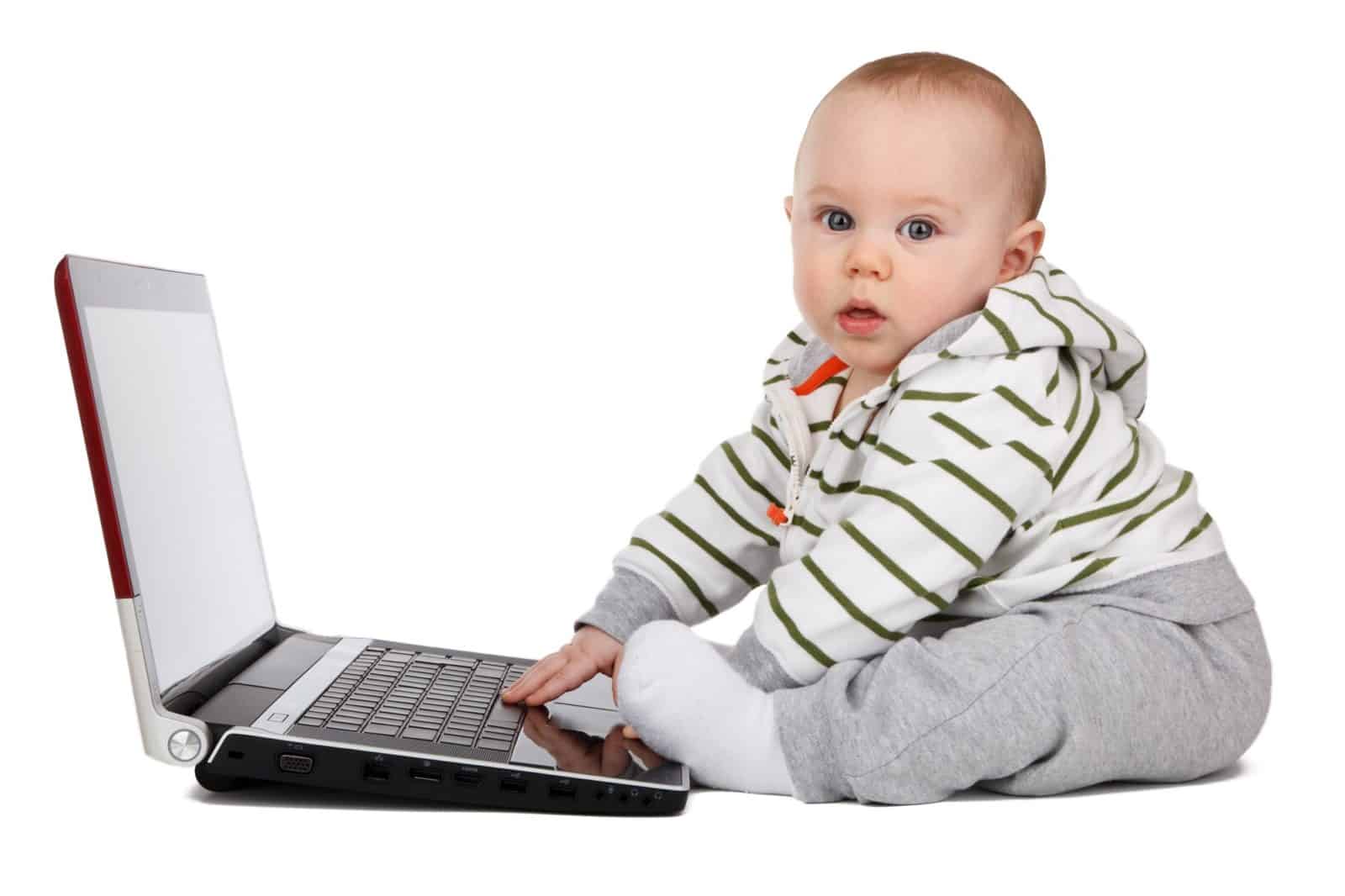 baby playing with laptop