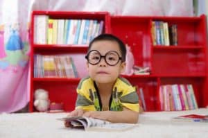 boy with glasses reading