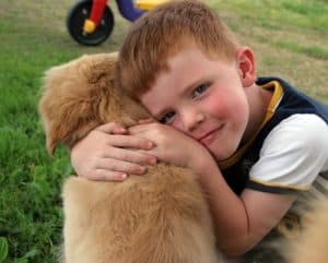 boy hugs dog
