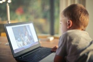 young boy watching a video on his laptop