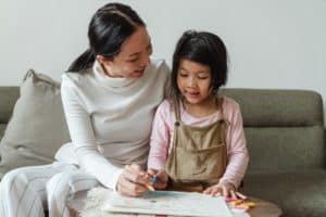 tutor teaching a young girl at home