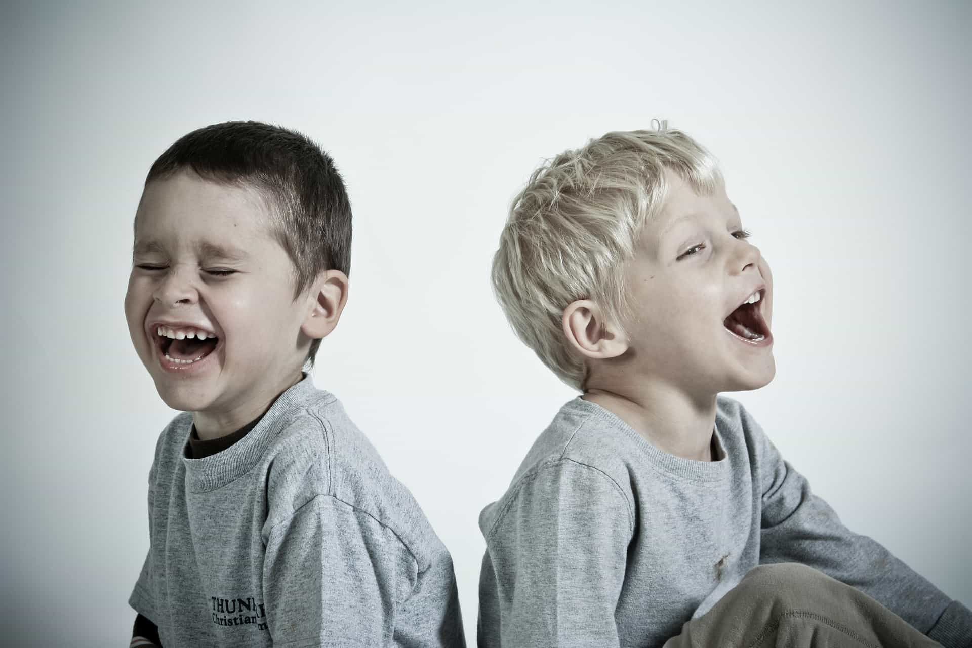 two boys sitting and laughing
