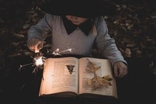child reading by sparkler