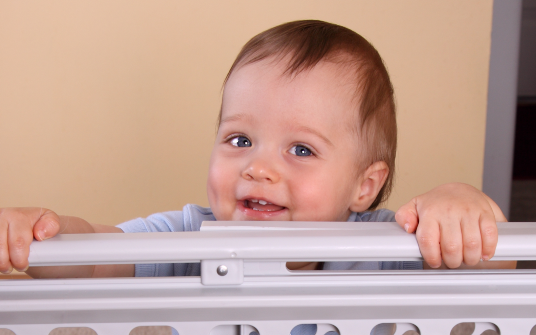 young child in front of a baby gate